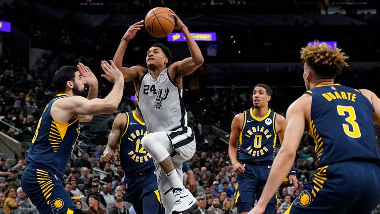 San Antonio Spurs&#39; Devin Vassell drives against Indiana Pacers players Chris Duarte, Tyrese Haliburton, Oshae Brissett and Goga Bitadze during the second half of an NBA basketball game in San Antonio,