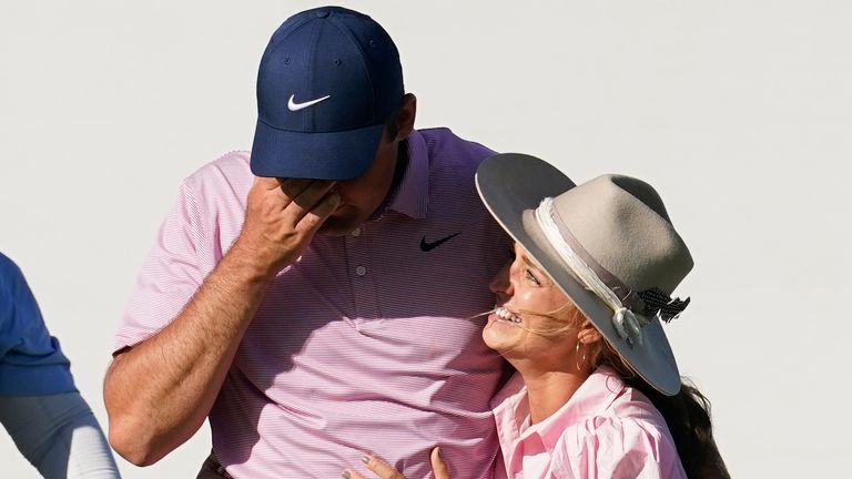 Scottie Scheffler, left, reacts as he gets a hug from his wife, Meredith, after winning the Dell Technologies Match Play Championship golf tournament, Sunday, March 27, 2022, in Austin, Texas. (AP Photo/Tony Gutierrez)