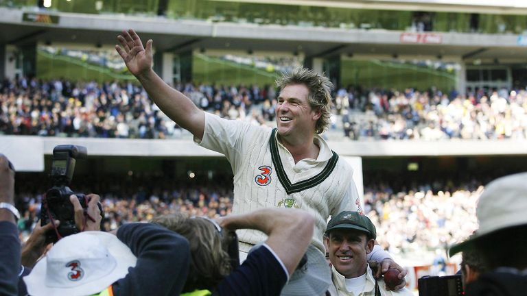 Australia's Shane Warne is lifted from the field by Andrew Symonds 