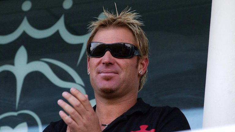 Shane Warne applauds from the dressing room after watching his Hampshire team mates beat Yorkshire