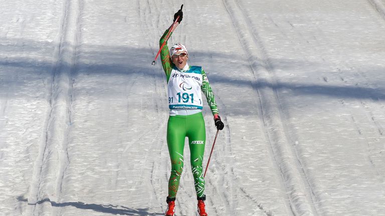 Sviatlana Sakhanenka of Belarus celebrates as she approaching to the finish line to win the women&#39;s 1.5km sprint classic, visually impaired, cross-country skiing at the 2018 Winter Paralympics in Pyeongchang, South Korea