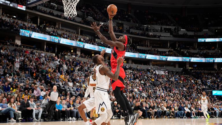 Toronto Raptors forward Pascal Siakam goes up for a basket over Denver Nuggets guard Davon Reed in the first half of an NBA basketball game