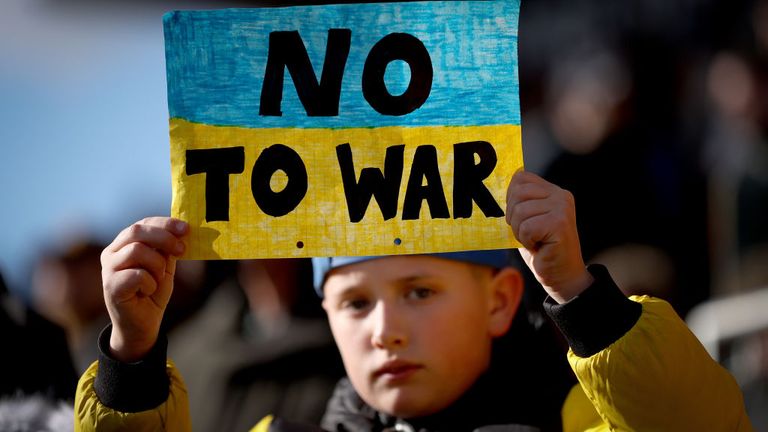 A young supporter with the 'No to War' message