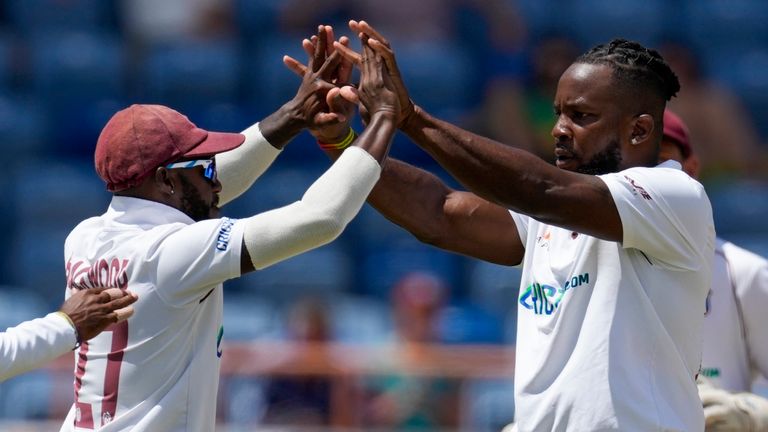 West Indies' Kyle Mayers, right, celeb rates with teammates Jermaine Blackwood and Kraigg Brathwaite the dismissal of England's Zak Crawley during day one of their third Test cricket match at the National Cricket Stadium in St. George, Grenada