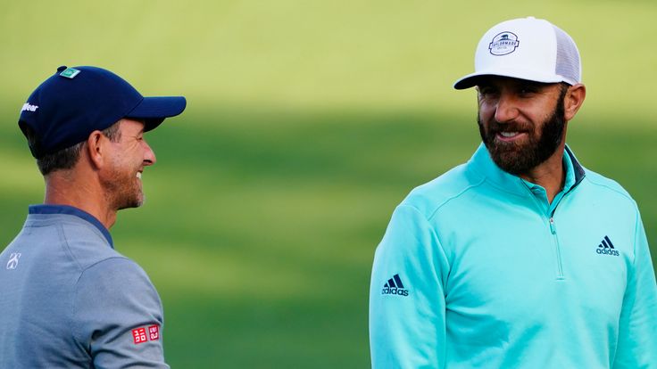 Adam Scott, left, of Australia, and Dustin Johnson chat on the driving range during a practice round for the Masters golf tournament on Monday, April 4, 2022, in Augusta, Ga. (AP Photo/Matt Slocun)