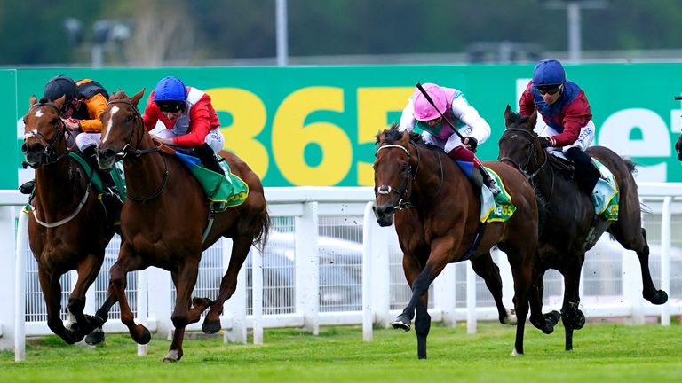 Lights On ridden by jockey Ryan Moore (second left, blue cap) on their way to winning the bet365 Mile