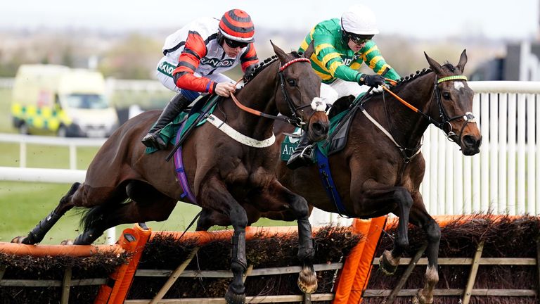 Party Business ridden by Charlie Todd (left) on their way to winning the EFT Construction Handicap Hurdle during Grand National Day of the Randox Health Grand National Festival 2022 at Aintree Racecourse, Liverpool. Picture date: Saturday April 9, 2022.