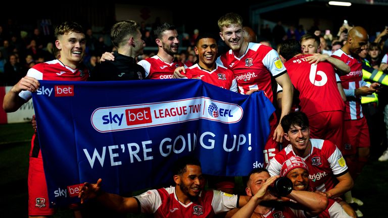 Exeter City players celebrate after gaining promotion to League One after the Sky Bet League Two match at St James Park, Exeter. Picture date: Tuesday April 26, 2022.