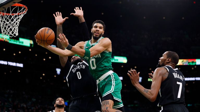 Boston Celtics&#39; Jayson Tatum passes off against Brooklyn Nets&#39; Andre Drummond, left, and Kevin Durant (7) during the second half of Game 2 of an NBA basketball first-round Eastern Conference playoff series, Wednesday, April 20, 2022, in Boston. (AP Photo/Michael Dwyer)