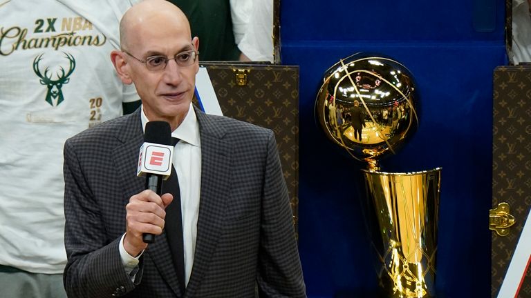 NBA commissioner Adam Silver presents the NBA championship trophy to the Milwaukee Bucks after Game 6 of the 2021 NBA Finals against the Phoenix Suns in Milwaukee