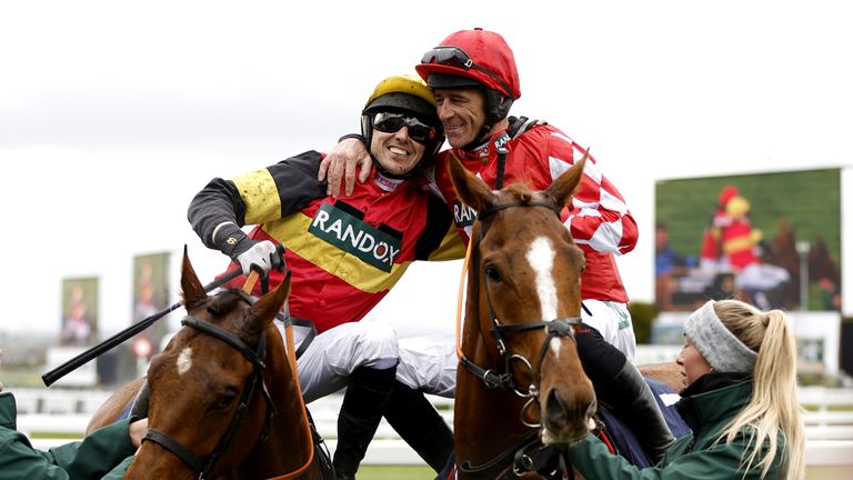 Paddy Brennan and Davy Russell embrace after a dead-heat was initially called 