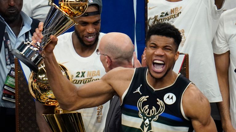 Milwaukee Bucks forward Giannis Antetokounmpo (34) holds up the MVP trophy after defeating the Phoenix Suns in Game 6 of basketball's NBA Finals in Milwaukee, Tuesday, July 20, 2021. The Bucks won 105-98. (AP Photo/Paul Sancya)