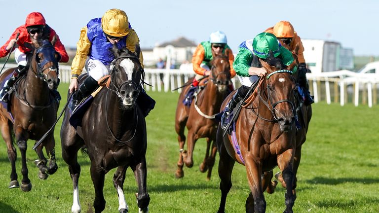 Arousing (green cap) wins on debut at Yarmouth