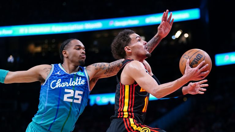 Atlanta Hawks guard Trae Young drives to the basket past Charlotte Hornets forward P.J. Washington