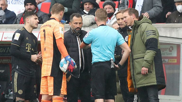 Referee Christian Dingert tries to clear up the confusion after Bayern Munich played with 12 men following a substitution mix-up