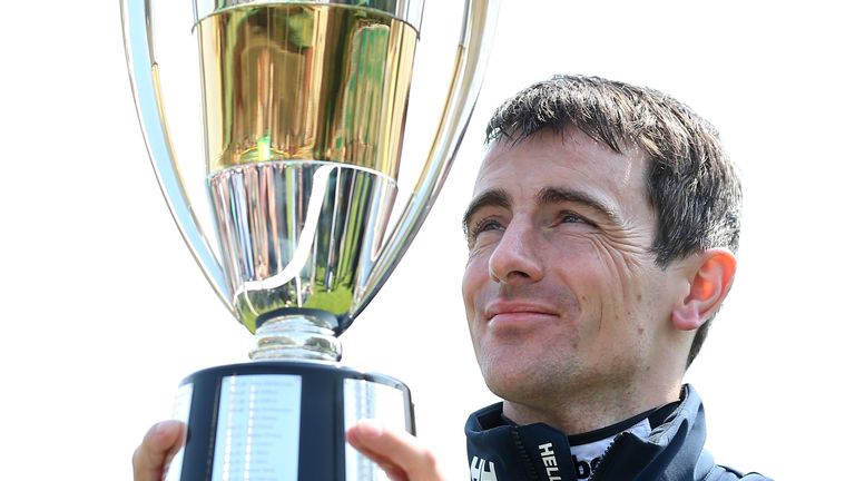 Brian Hughes lifts the champion jockey trophy for the second time