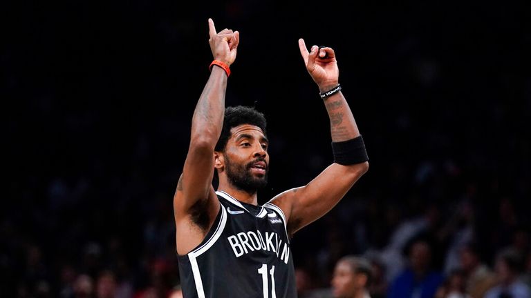 Brooklyn Nets&#39; Kyrie Irving reacts after sinking a basket during the second half of the opening basketball game of the NBA play-in tournament against the Cleveland Cavaliers, Tuesday, April 12, 2022, in New York. (AP Photo/Seth Wenig)