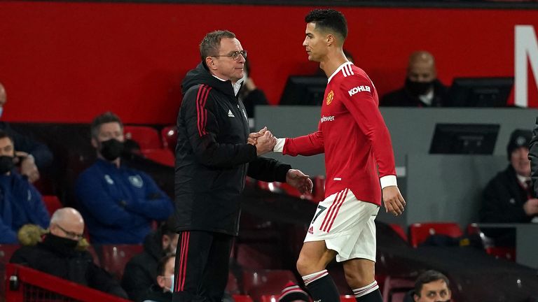 Manchester United's Cristiano Ronaldo (right) shakes hands with manager Ralf Rangnick after replacing Fred during a Premier League match at Old Trafford in Manchester.