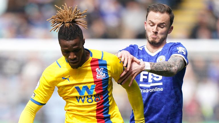 Crystal Palace player Wilfried Zaha and Leicester City player James Madison compete for the ball.