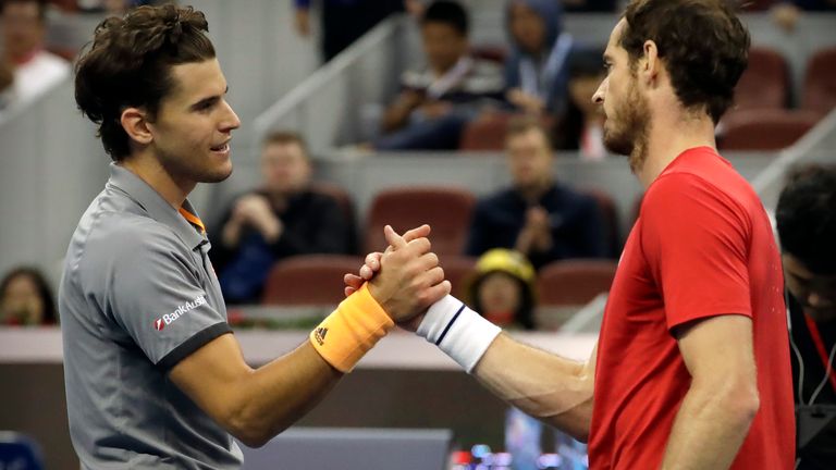 Dominic Thiem of Austria, left, is congratulated by Andy Murray of Britain after beating Murray in their quarterfinal match in the China Open tennis tournament in Beijing, Friday, Oct. 4, 2019. (AP Photo/Mark Schiefelbein)