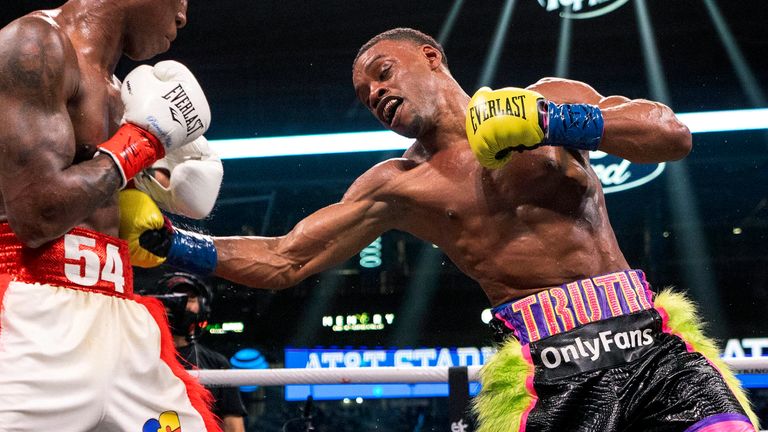 Errol Spence Jr., right, lands a punch on Yordenis Ugas, from Cuba, during a unified world welterweight championship boxing match, Saturday, April 16, 2022, in Arlington, Texas. Spence Jr. won by technical knockout in 10 rounds. (AP Photo/Jeffrey McWhorter)