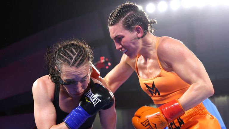 COSTA MESA, CALIFORNIA - APRIL 09: Jennifer Han (L) and Mikaela Mayer (R) exchange punches during their WBO and IBF junior lightweight championship fight at The Hangar on April 09, 2022 in Costa Mesa, California. (Photo by Mikey Williams/Top Rank Inc via Getty Images)