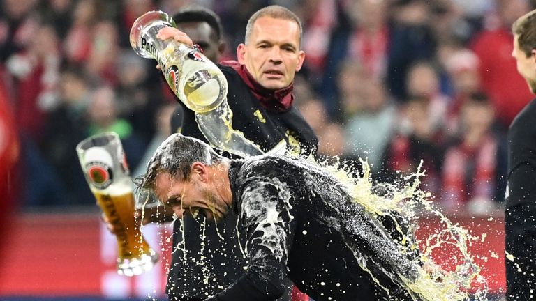 Bayern Munich manager Julian Nagelsmann is doused in beer after Bayern's title-clinching win