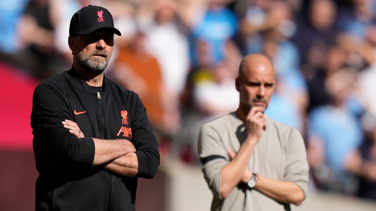 Jurgen Klopp and Pep Guardiola stand on the touchline at Wembley (AP)