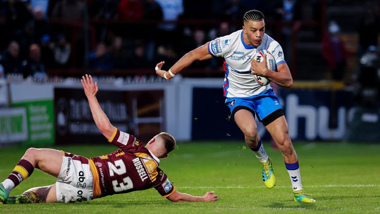 Picture by Alex Whitehead/SWpix.com - 28/04/2022 - Rugby League - Betfred Super League: Round 11 - Wakefield Trinity vs Huddersfield Giants - Be Well Support Stadium, Wakefield, England - Wakefield’s Lewis Murphy escapes the tackle of Huddersfield’s Oliver Russell.