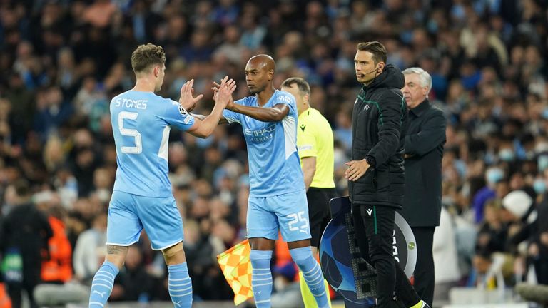 Manchester City's John Stones, left, is substituted by Manchester City's Fernandinho during the Champions League semi final, first leg soccer match between Manchester City and Real Madrid at the Etihad stadium in Manchester, England, Tuesday, April 26, 2022.