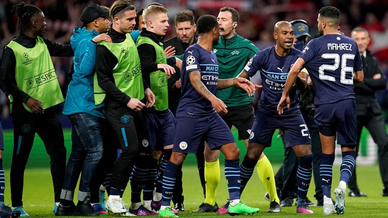 Manchester City's Fernandinho (second right) interspersed between Atletico Madrid's coach Diego Simeone (centre) and Riyad Mahrez at the end of the UEFA Champions League quarter-final, second leg at the Wanda Metropolitano Stadium in Madrid.  Date taken: Wednesday, April 13, 2022.