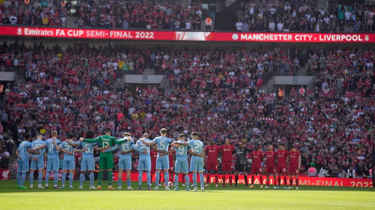 Manchester City and Liverpool players stand for a moment of silence to remember those who died in the 1989 Hillsborough disaster (AP)