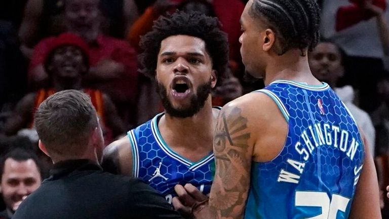 Charlotte Hornets forward Miles Bridges is restrained by PJ Washington and others as he argues with an official after being charged with a foul during the Play-In Tournament clash against the Atlanta Hawks