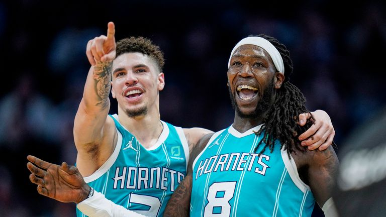 Charlotte Hornets guard LaMelo Ball, left, and center Montrezl Harrell (8) view the replay board following an altercation during the second half of an NBA basketball game against the Orlando Magic on Thursday, April 7, 2022, in Charlotte, N.C. (AP Photo/Rusty Jones)