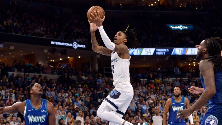 Memphis Grizzlies guard Ja Morant (12) shoots during he first half during Game 1 of the team&#39;s first-round NBA basketball playoff series against the Minnesota Timberwolves on Saturday, April 16, 2022, in Memphis, Tenn.