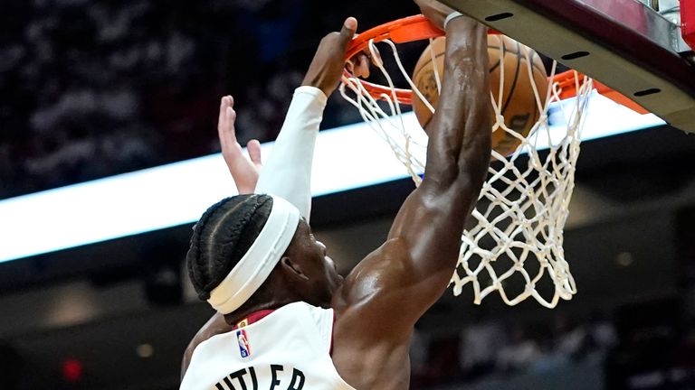 Miami Heat forward Jimmy Butler (22) dunks over Atlanta Hawks forward Danilo Gallinari (8) during the first half of Game 1 of an NBA basketball first-round playoff series, Sunday, April 17, 2022, in Miami.