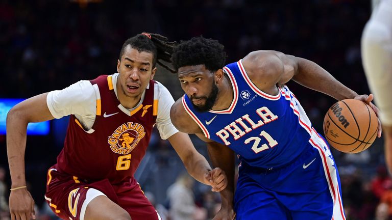 Philadelphia 76ers center Joel Embiid, right, drives against Cleveland Cavaliers center Moses Brown in the second half of an NBA basketball