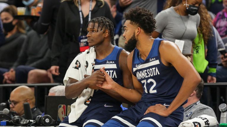 Minnesota Timberwolves center Karl-Anthony Towns (32) and Timberwolves forward Anthony Edwards (1) shake during an NBA basketball game against the Houston Rockets