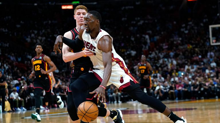 Miami Heat center Bam Adebayo, drives to the basket as Atlanta Hawks guard Kevin Huerter defends