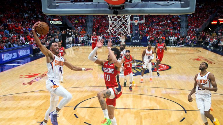 Phoenix Suns guard Landry Shamet (14) drives to the basket as New Orleans Pelicans center Jaxson Hayes (10) defends during the first half of Game 3 of an NBA basketball first-round playoff series in New Orleans, Friday, April 22, 2022.