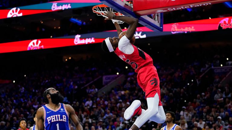 Toronto Raptors&#39; Chris Boucher (25) dunks past Philadelphia 76ers&#39; James Harden (1) during the first half of Game 5 in an NBA basketball first-round playoff series, Monday, April 25, 2022