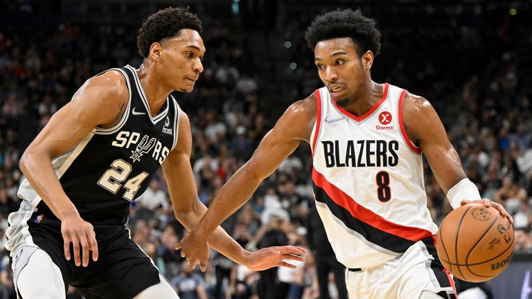 Portland Trail Blazers&#39; Brandon Williams (8) drives against San Antonio Spurs&#39; Devin Vassell during the first half of an NBA basketball game on Sunday