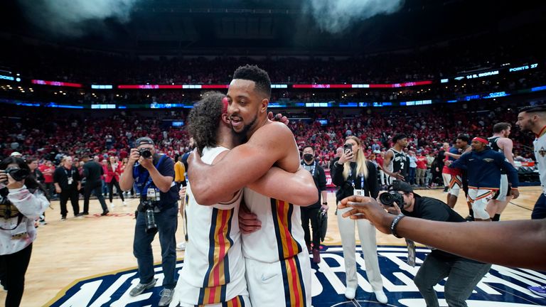 New Orleans Pelicans guard CJ McCollum hugs guard Jose Alvarado after defeating the San Antonio Spurs.