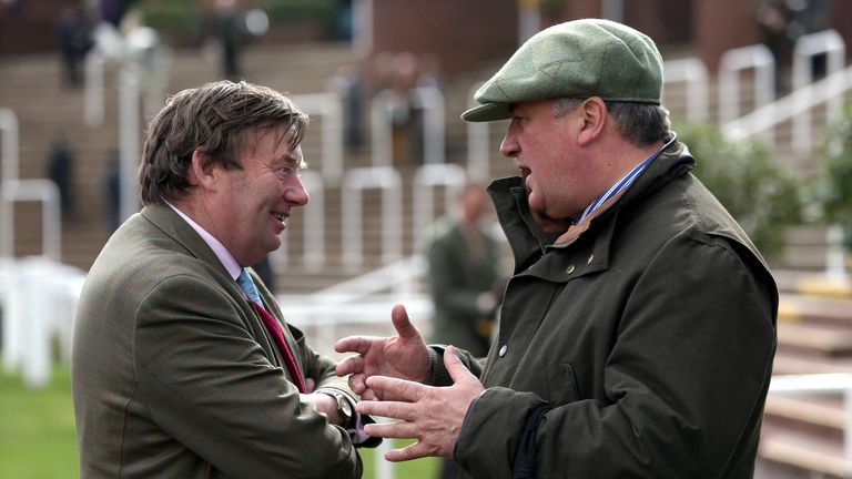 Nicky Henderson (left) trails Paul Nicholls (right) by over £250,000 in the jumps trainers' championship