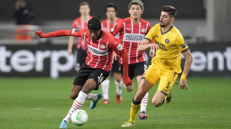 PSV's Noni Madueke, left, controls the ball past Maccabi's Idan Nachmias during the second leg play-off Conference League soccer match between Maccabi Tel Aviv and PSV in Bloomfield stadium in Tel Aviv, Israel, Thursday, Feb. 24, 2022. 