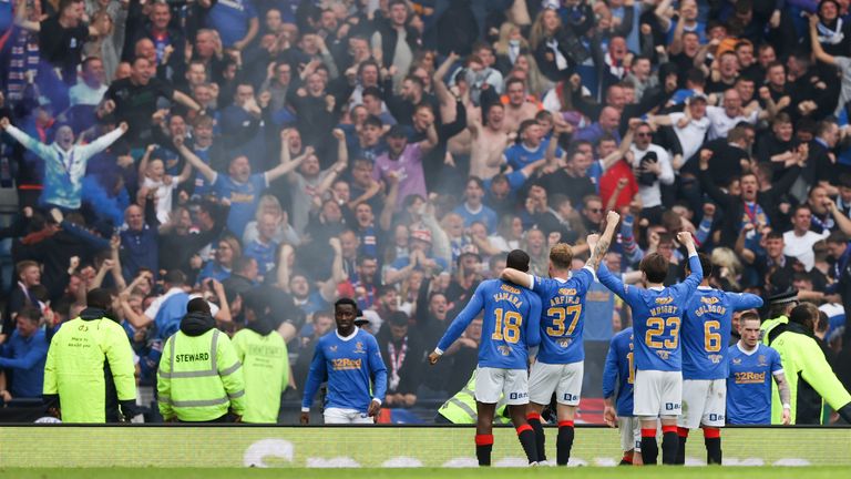 Rangers players celebrate in front of their fans at full time