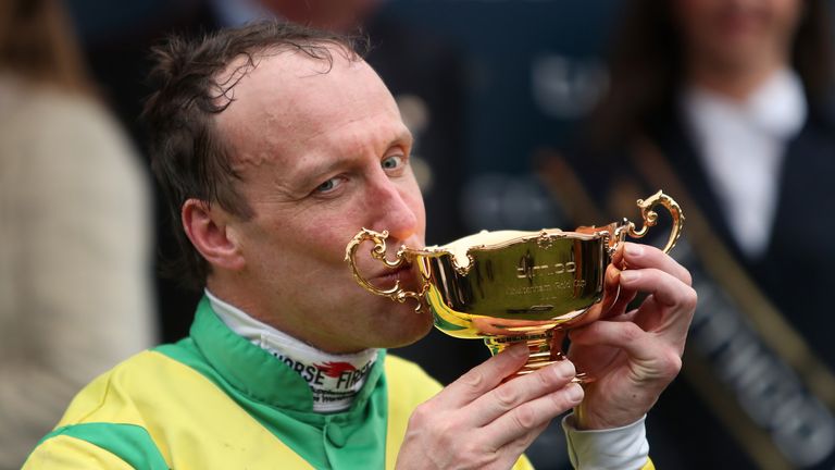 Jockey Robbie Power kisses the Cheltenham Gold Cup trophy after his winning ride on Sizing John