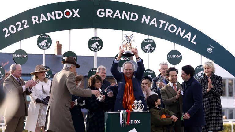 Robert Willie Cohen lifts the Grand National trophy after winning with Noble Yates at Aintree.