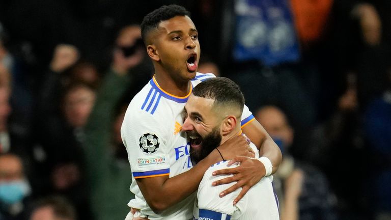 Real Madrid&#39;s Rodrygo, left, celebrates with his team-mate Karim Benzema