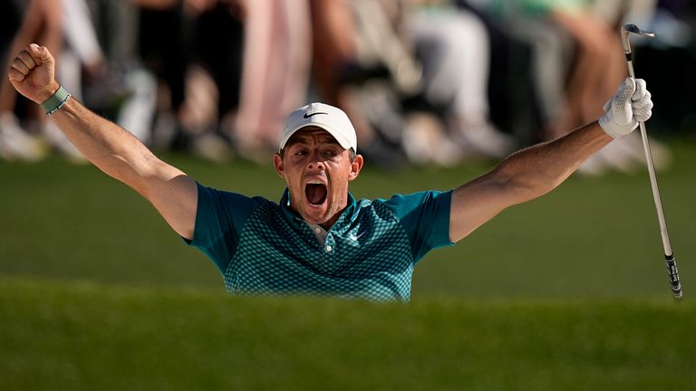 Rory McIlroy reacts after holing out from the bunker for a birdie during the final round at The Masters